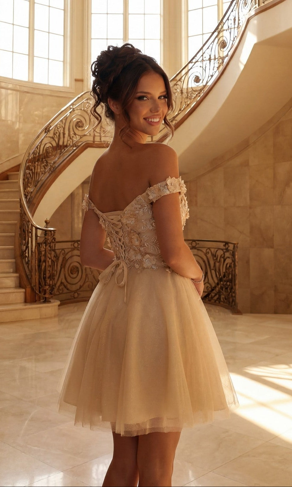 A young woman wearing the Beaded-Bodice Short A-Line Homecoming Dress C315 stands on a marble floor before an ornate staircase, glancing over her shoulder with a smile.